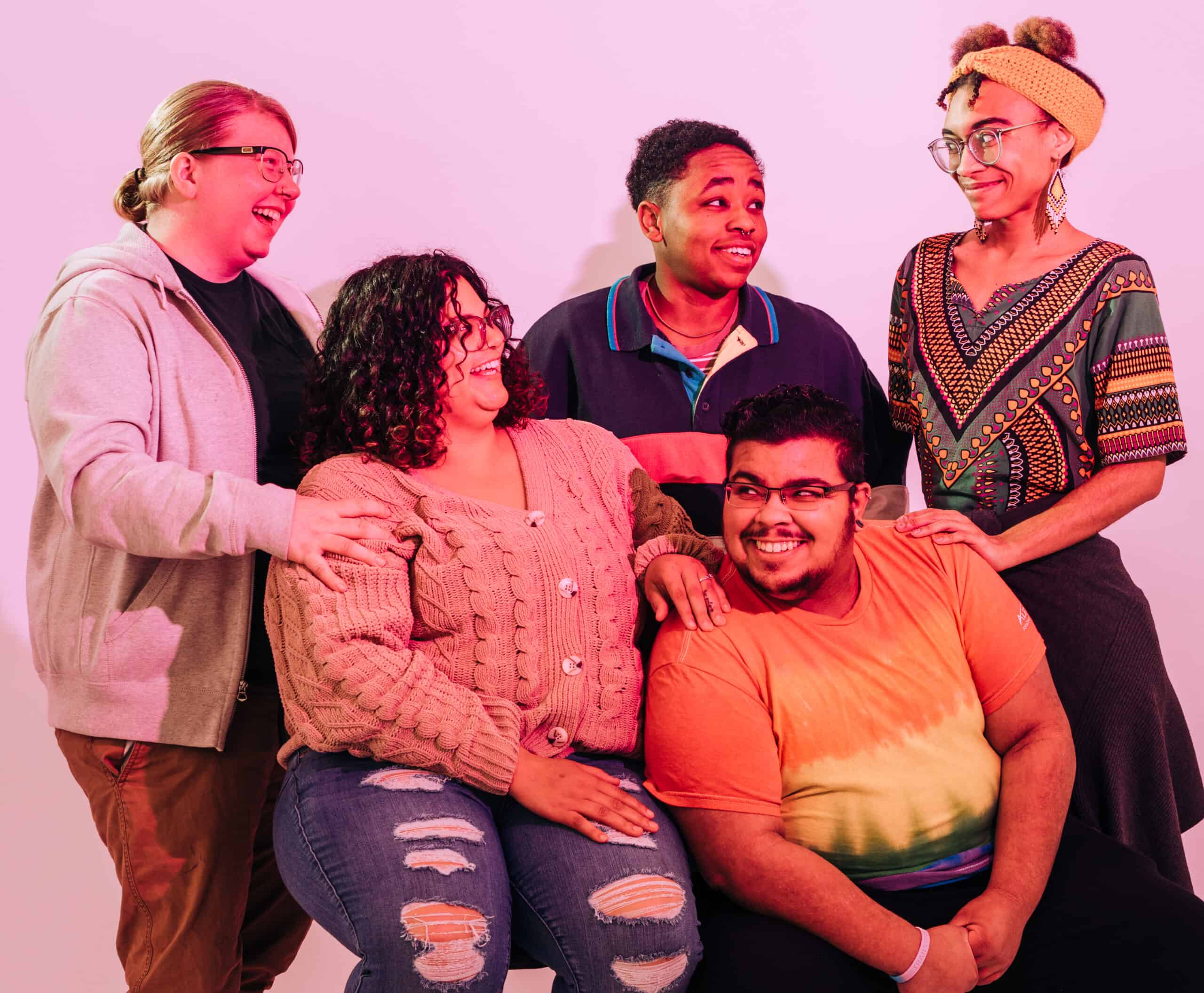 A group of happy smiling queer people.