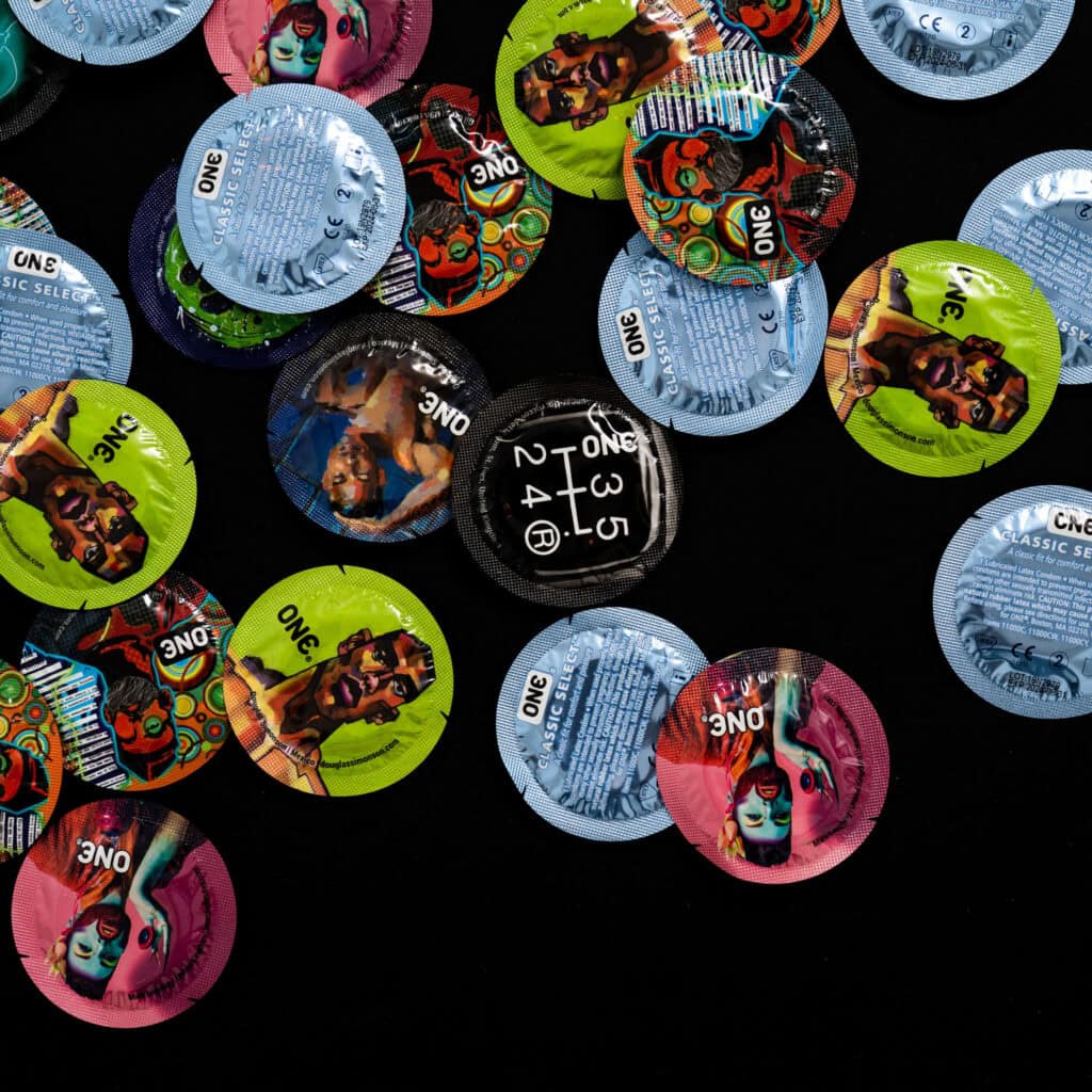 Condoms against a black background.