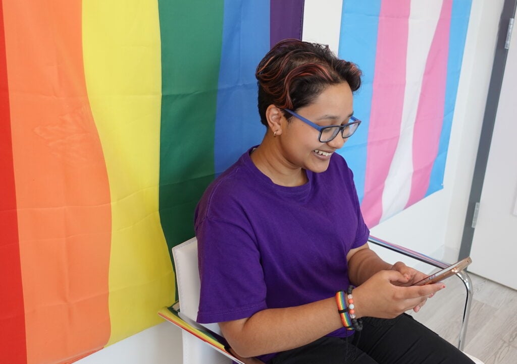 An individual on their phone in Anchor Health's waiting room.